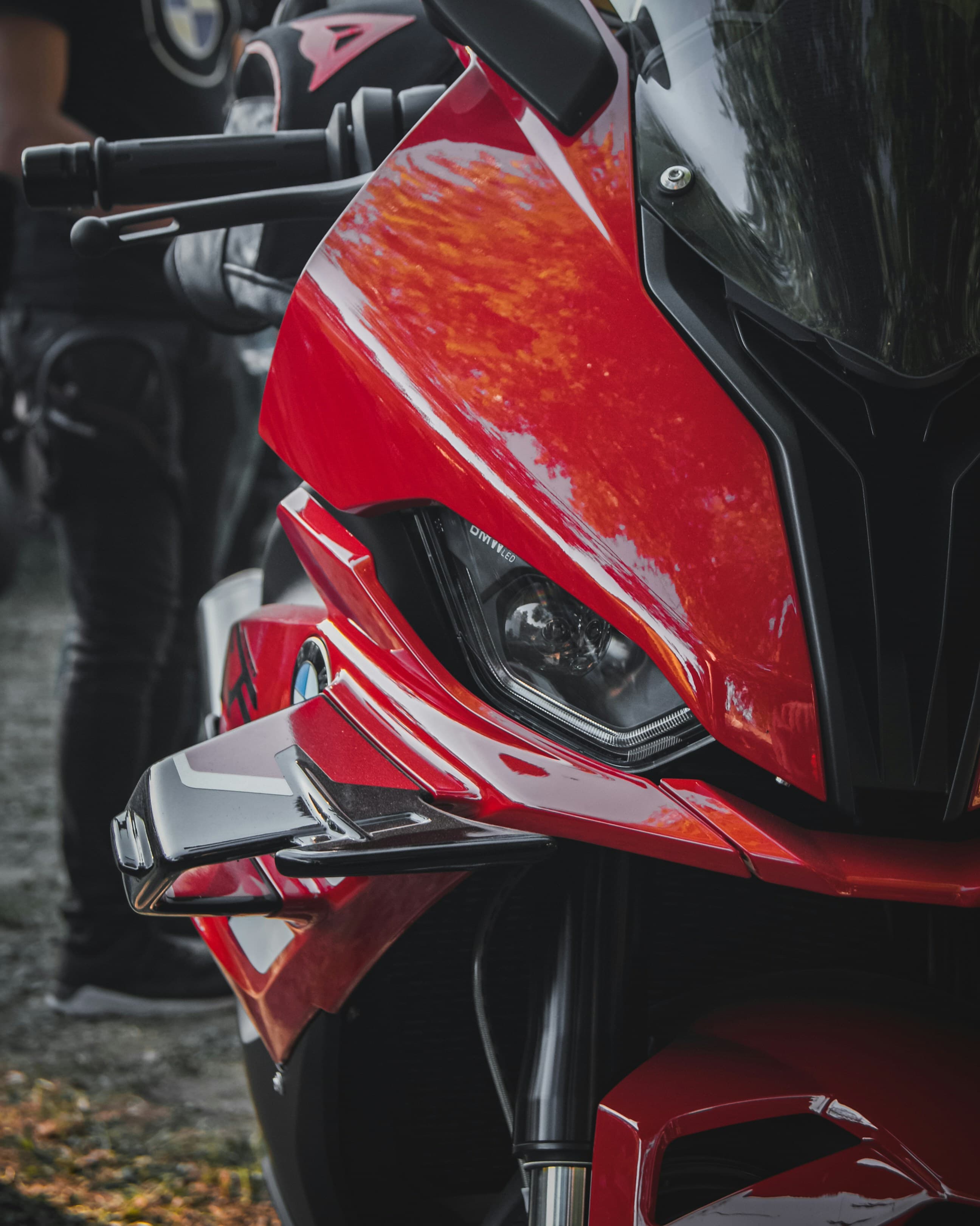 Carénage rouge d'une moto sportive garée au paddock avant une session sur piste